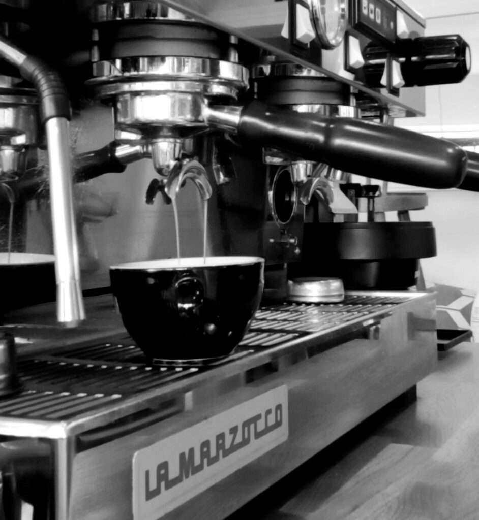 Extracting a double espresso on the Marzocco - b&w